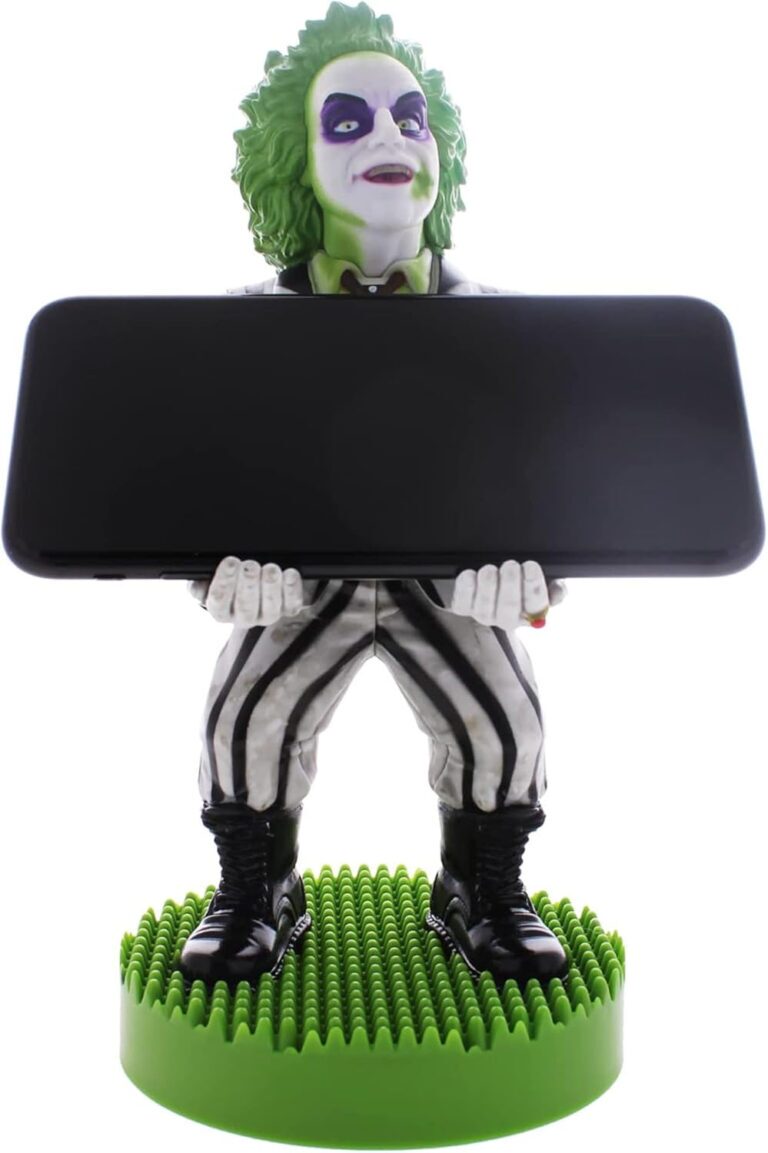 Just in time for the new Beetlejuice film, the ghost with the most is back in action! This time, he's not just causing trouble in the afterlife but is ready to bring his quirky energy to your gaming setup with the officially licensed Beetlejuice Cable Guy Phone & Gaming Controller Stand. Styled after his unmistakable look, this stand is designed to hold your smartphone, remote control, or gaming controller with a mischievous twist. A video game controller with a green and white garmentDescription automatically generated For those who remember the classic 1988 Beetlejuice film, you'll know that this trickster ghost, with his grisly green hair, iconic black-and-white striped suit, and sandworm-stomping boots, is a "professional" in wreaking havoc. Now, thanks to this unique accessory, you can channel that chaotic energy straight to your gaming station. Perfect for die-hard fans of both the original and the upcoming film, this stand blends nostalgia with modern-day practicality. A toy in a boxDescription automatically generated Product Features: Universal Compatibility: Whether you're gaming on the PlayStation 5 DualSense, Xbox Series S/X, or checking your iPhone. Stunning Design: Standing approximately 8.5" tall, Beetlejuice holds your devices with his usual unkempt, grisly charm. It's the perfect blend of fun and function, making it a great gift for fans of the franchise. Officially Licensed: Styled directly from the original Beetlejuice design by ExgPro, it is officially licensed by Warner Brothers, guaranteeing quality and authenticity. The Perfect Gift for Any Beetlejuice Fan Beetlejuice has always been a character who brings a sense of fun, and this stand is no exception. Whether you're a long-time fan of the original Tim Burton film or excited for the new Beetlejuice movie, this accessory is sure to add some mischievous flair to your home. So, why settle for an ordinary phone or controller holder when you can have a trickster ghost on standby? Bring Beetlejuice home today and let him haunt your gaming setup in style! The ExgPro Beetlejuice Cable Guys costs £29.99 from HMV